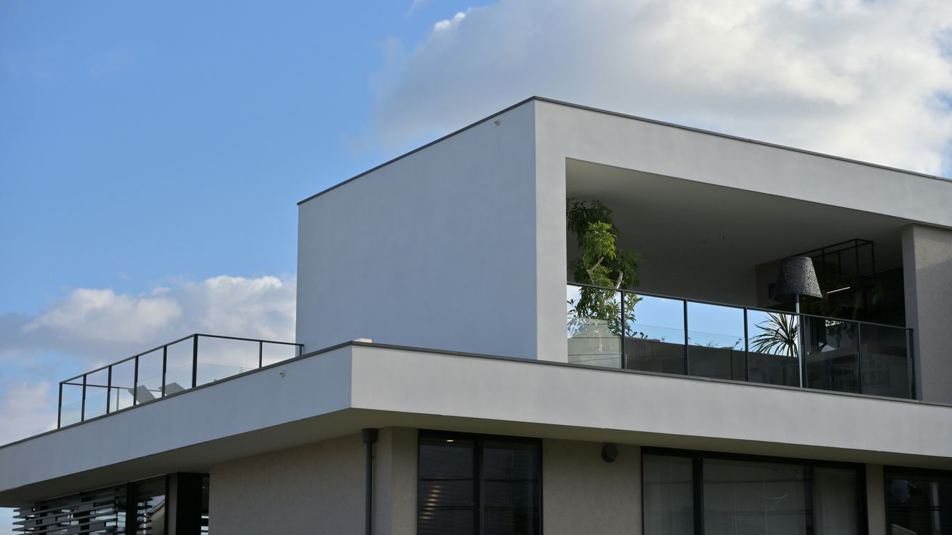 A large white building with a balcony and balconies