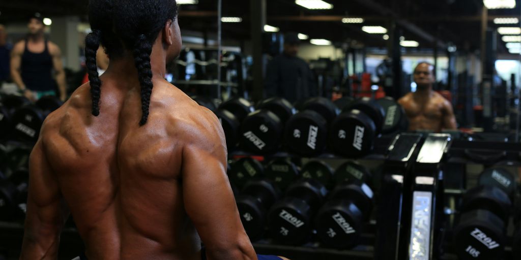 a man with no shirt in a gym