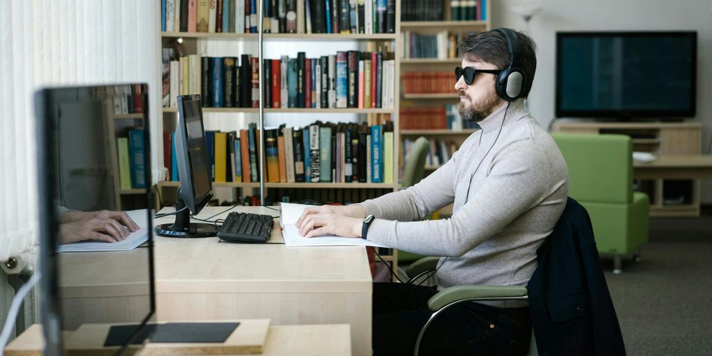 A man sitting at a desk with headphones on
