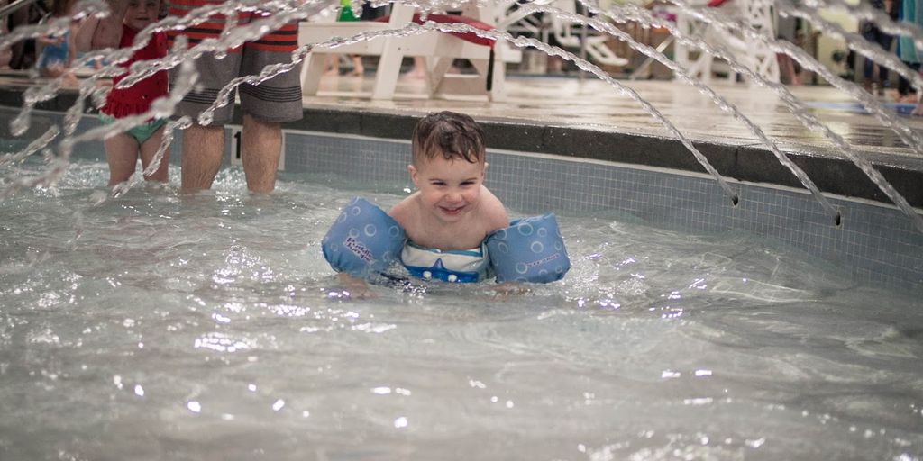 swimmer eating honey snack poolside