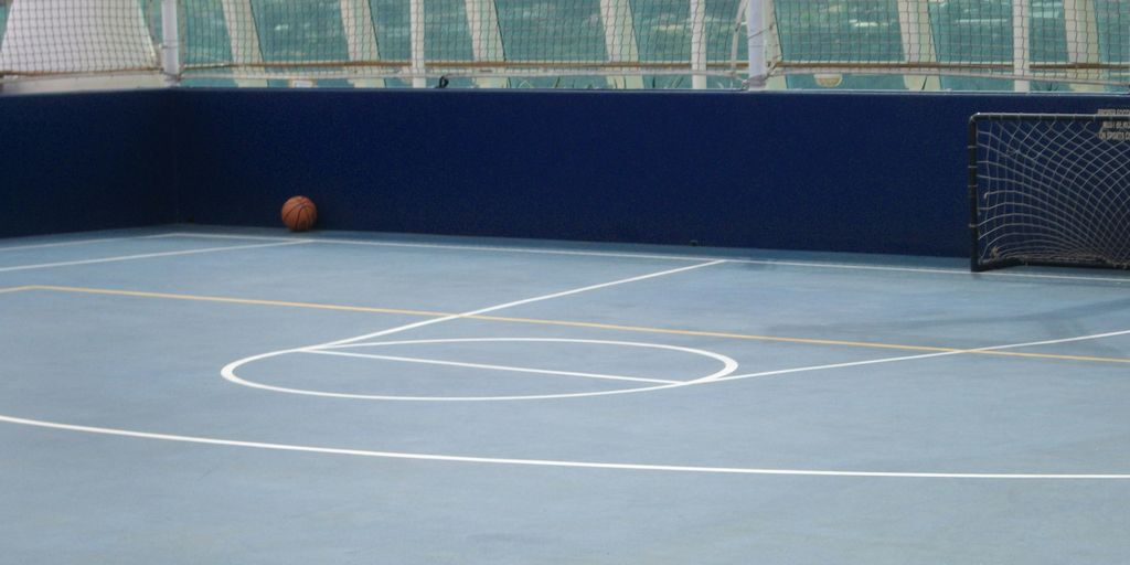 a man standing on a tennis court holding a racquet