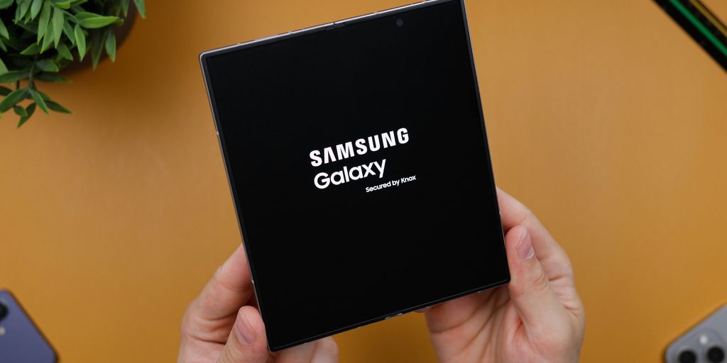 A person holding a black box with the samsung logo on it