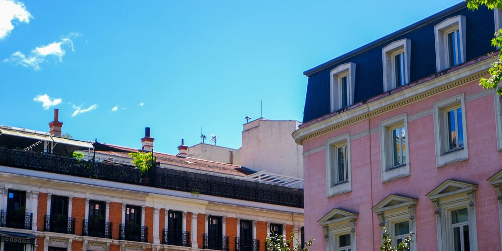 Buildings and a bright blue sky make up the image.