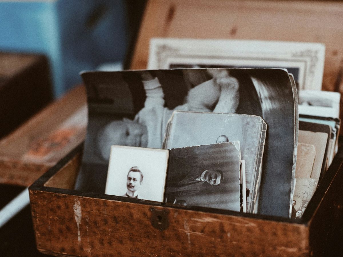 old photos in brown wooden chest