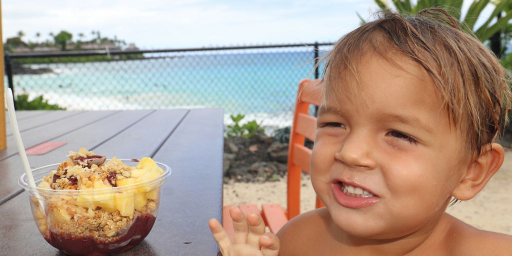boy holding a cake with white icing