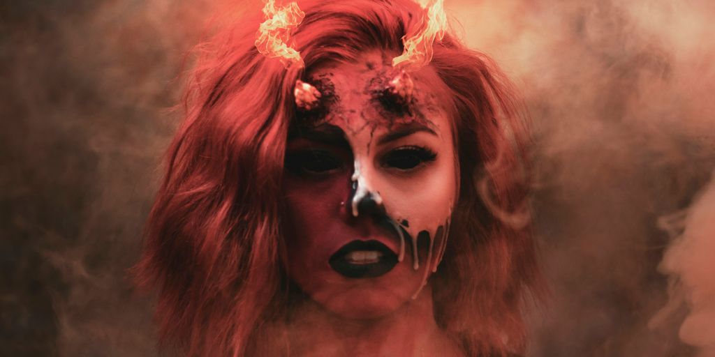 a woman with pink hair and a flower crown