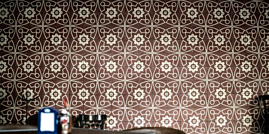 a room with a table and a wall with a pattern on it