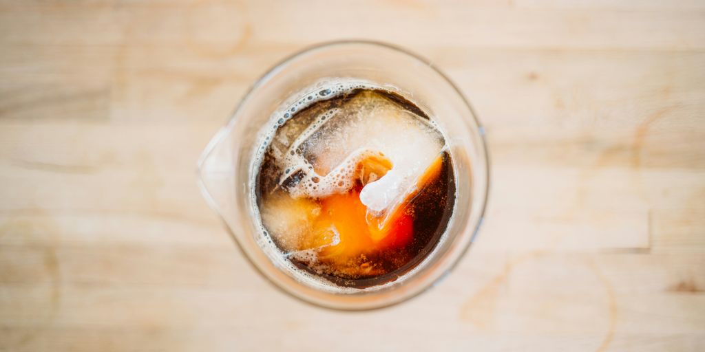 clear glass pitcher with red and black labeled liquid