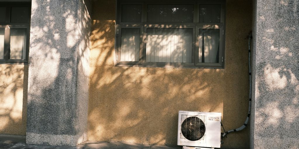 an air conditioner sitting on the side of a building
