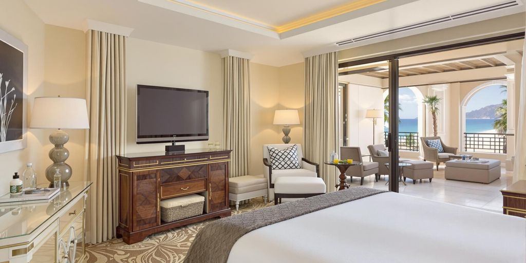 Luxurious hotel room with ocean view and elegant decor.