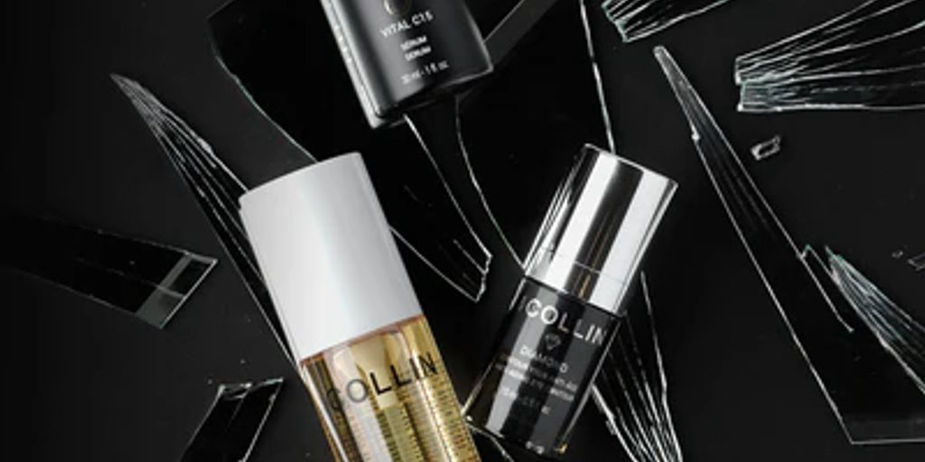 Cosmetic products displayed among artistic shattered glass aesthetic.