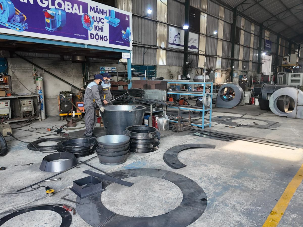 A workshop filled with machinery, materials, and a person working.