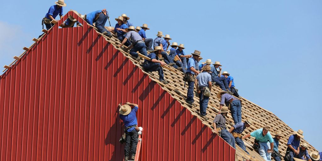 group of construction workers constructing house