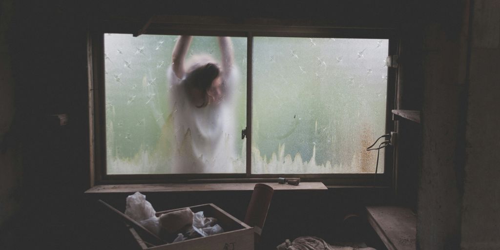 woman leaning on window