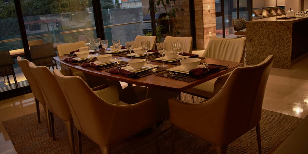 a dining room table set with place settings