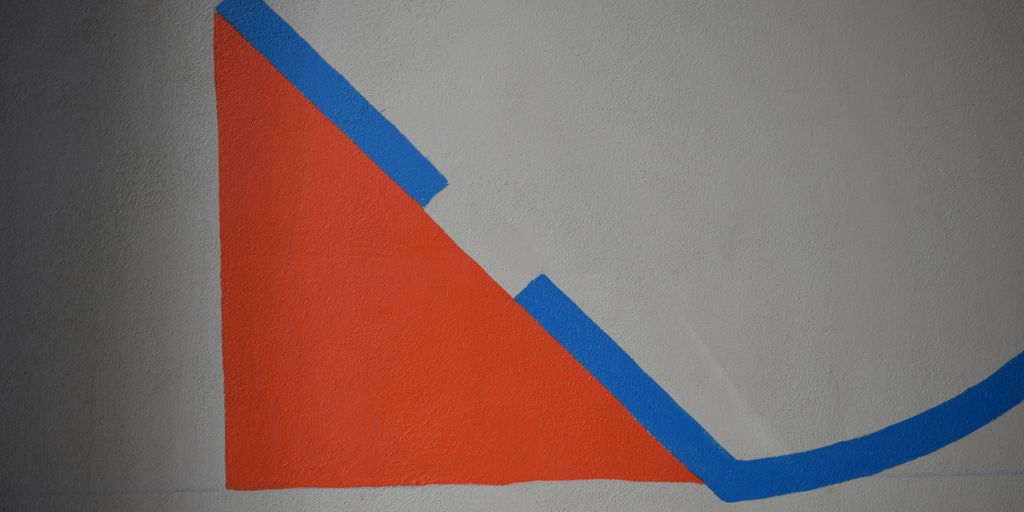 a drawing of a triangle on a white wall