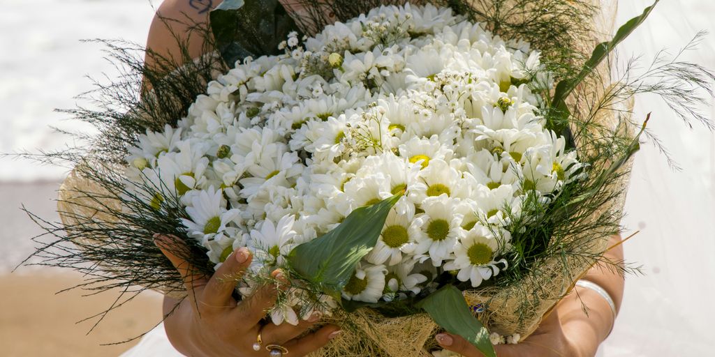 woman holding white flower bouquet