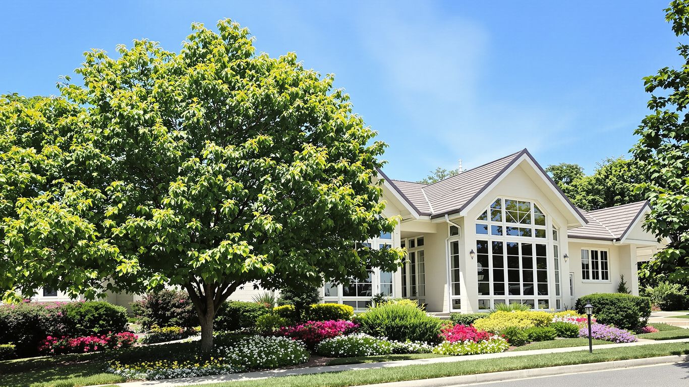 Modern house with green lawn and blue sky.