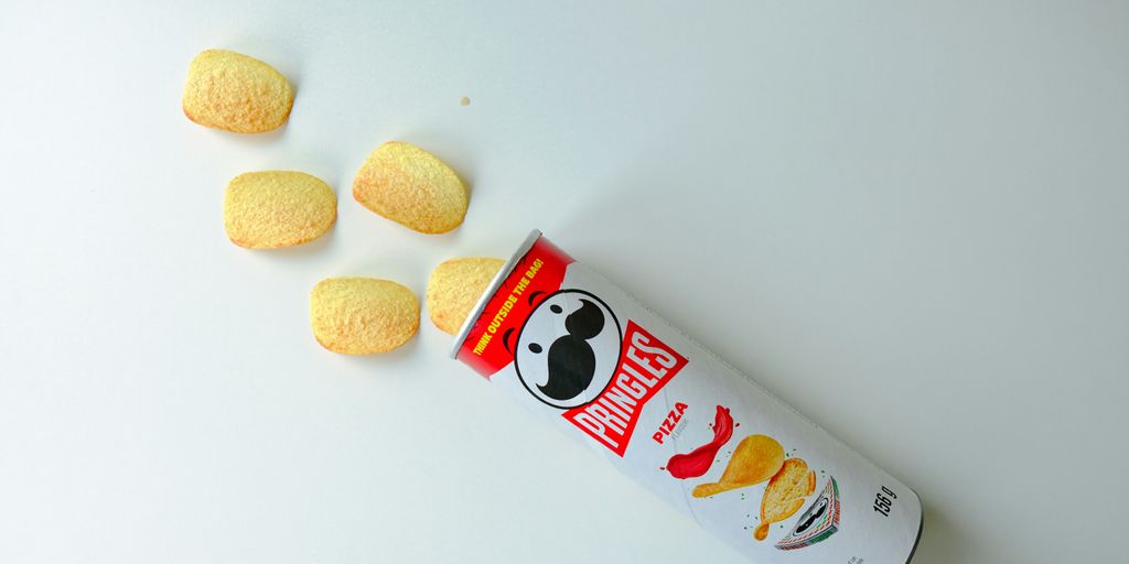 a can of macaroni and cheese on a white surface