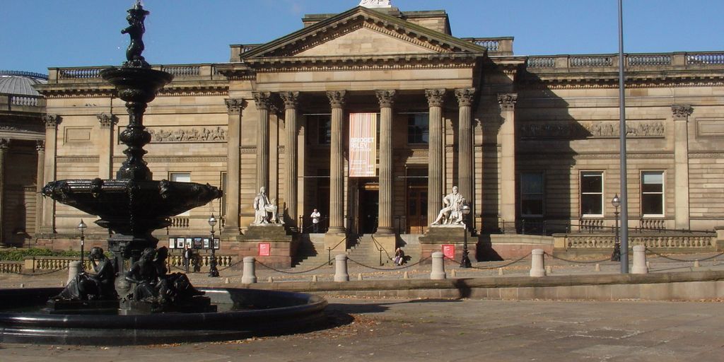 art lovers exploring museums and galleries in Birmingham with vibrant street art in the background