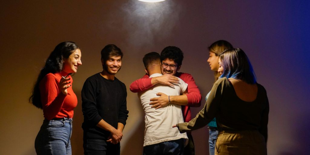 Friends embrace each other in a warm hug.