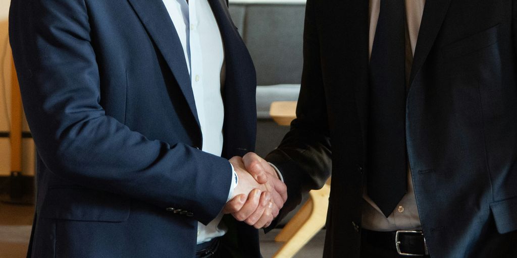 Two business partners shaking hands in agreement.