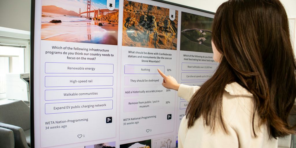 a woman pointing at a poster on a wall
