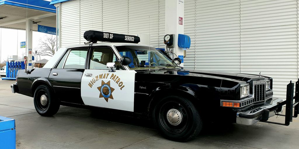 a police car parked in front of a building