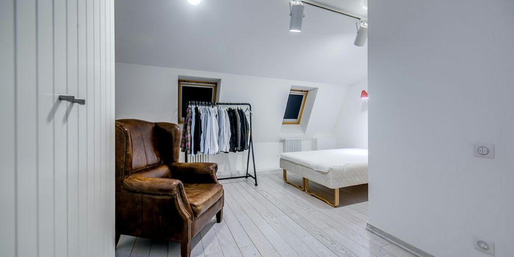 a room with a chair and a bed in it