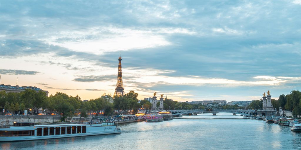 a view of a river with boats on it and the eiffel tower in