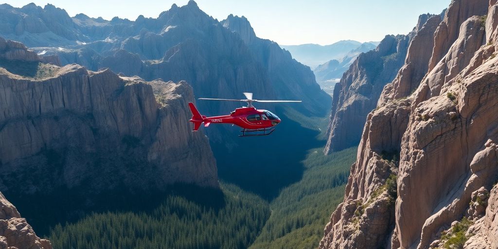 A red helicopter flying through a deep mountain canyon.