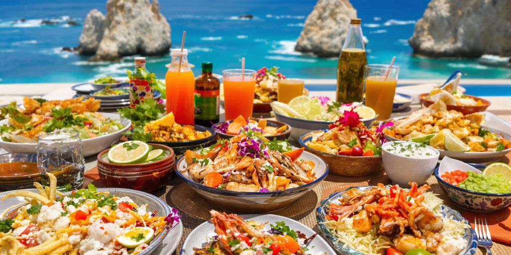 Colorful Mexican dishes with seafood and coastal backdrop.