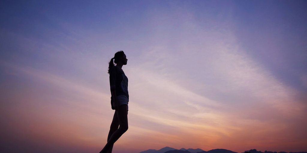 woman standing under blue sky