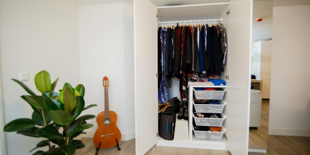 hanged assorted-colored clothes in white cabinet