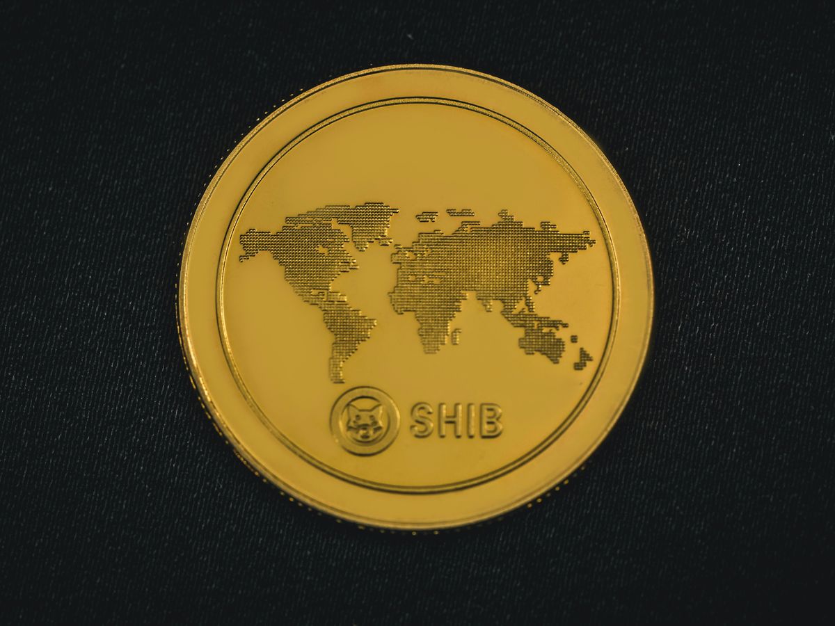 a gold coin with a world map on it