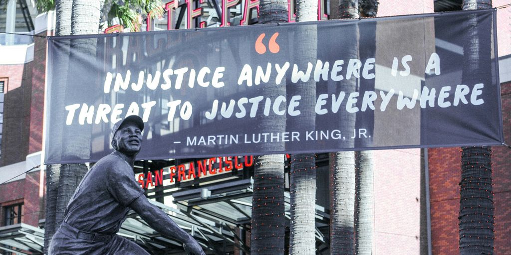 man in black jacket and pants sitting on bench