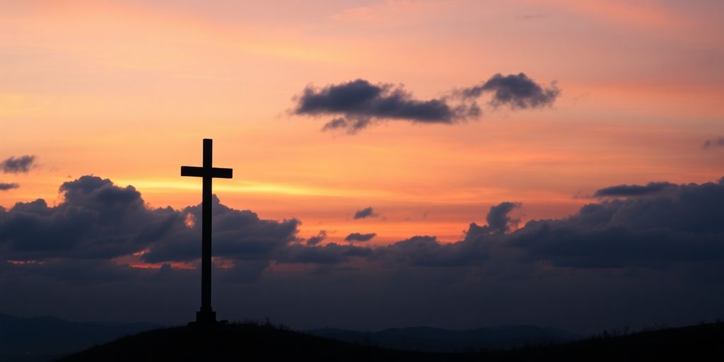 Silhouetted cross against a colorful sunset sky.