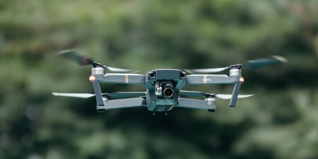 gray and black drone in mid air during daytime