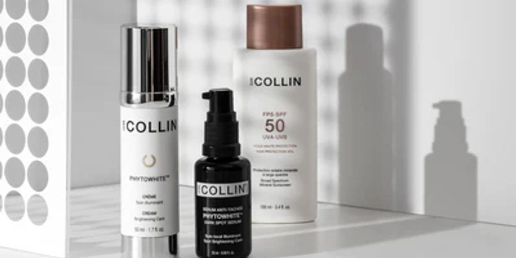 Three skincare products on a countertop with a shadowy background.