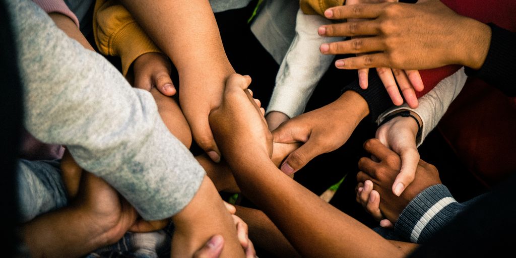 a group of people holding hands