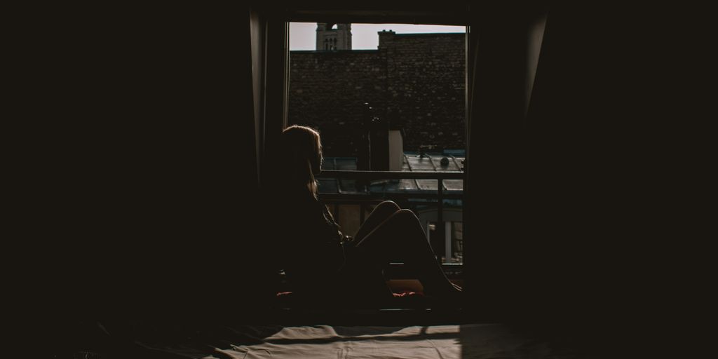 woman looking outside from the window