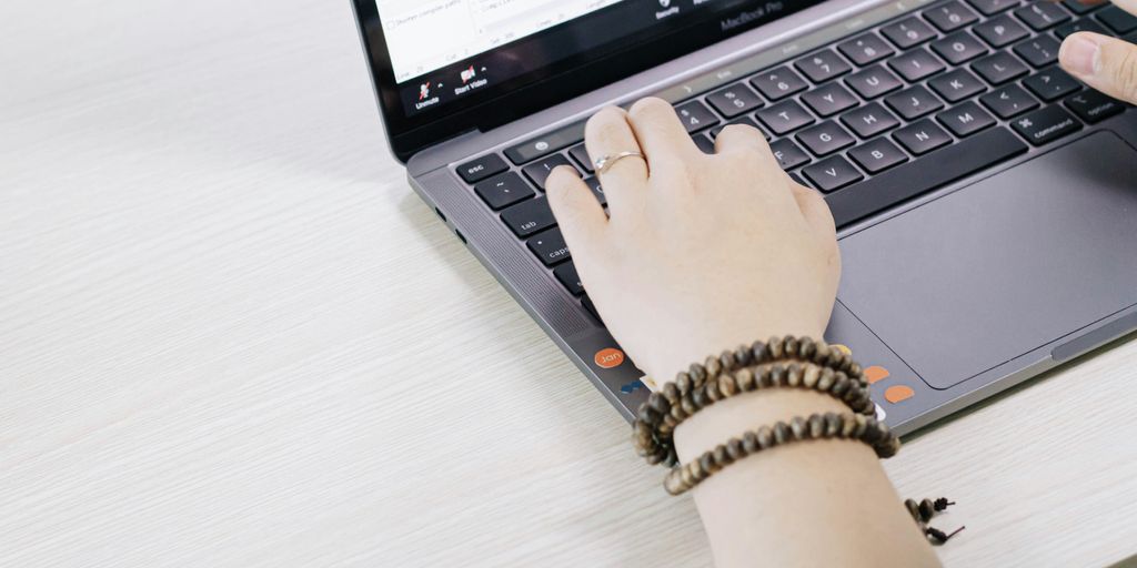 person using black and silver laptop computer