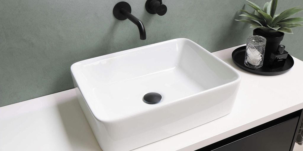 white ceramic sink with stainless steel faucet
