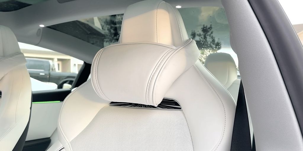 Interior view of a modern car seat with a headrest.