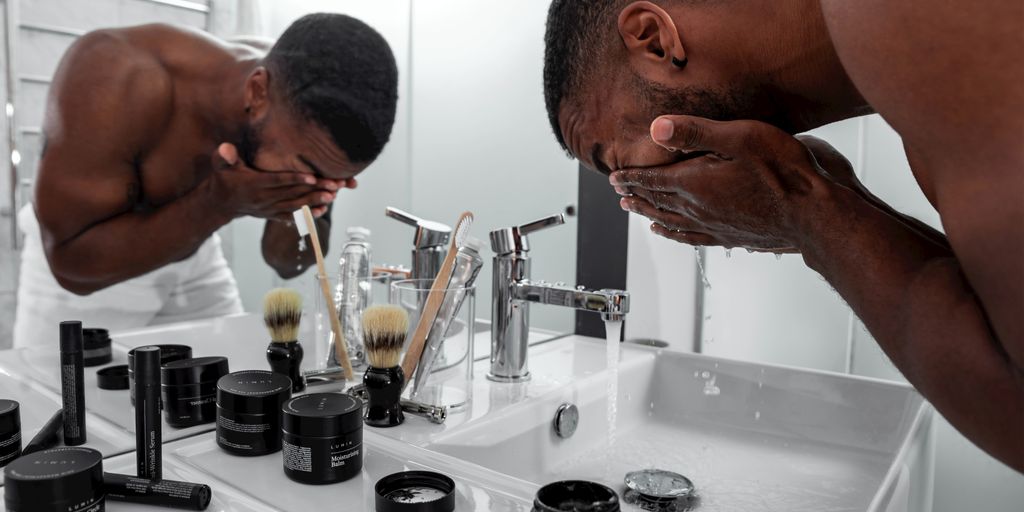 man standing in front of sink
