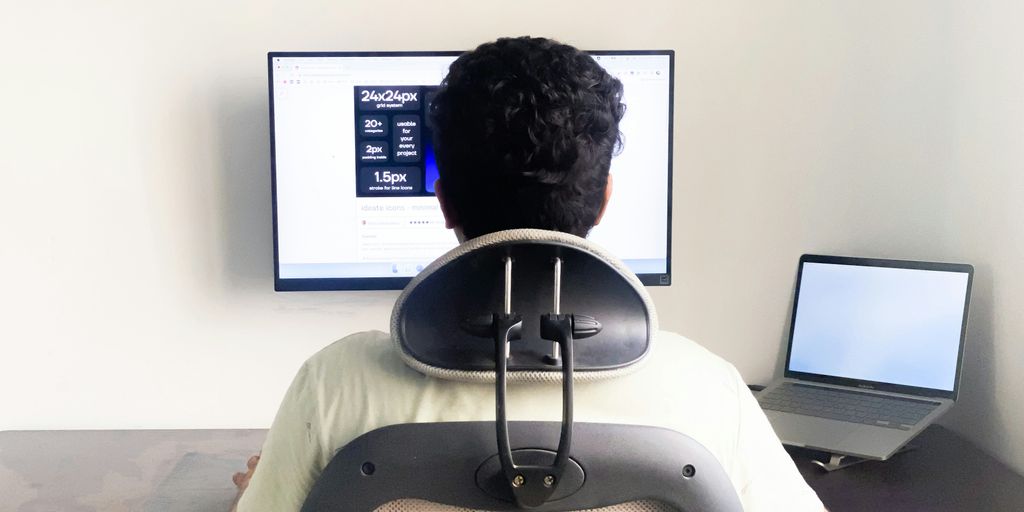 a man sitting in front of a computer monitor