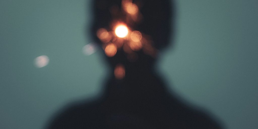 a person's head with a light shining on it