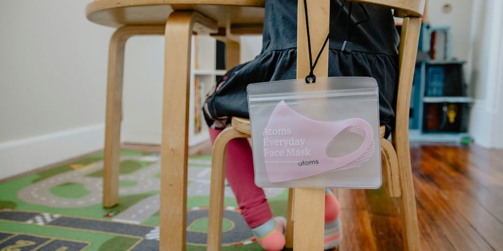 pink and white plastic container on brown wooden table