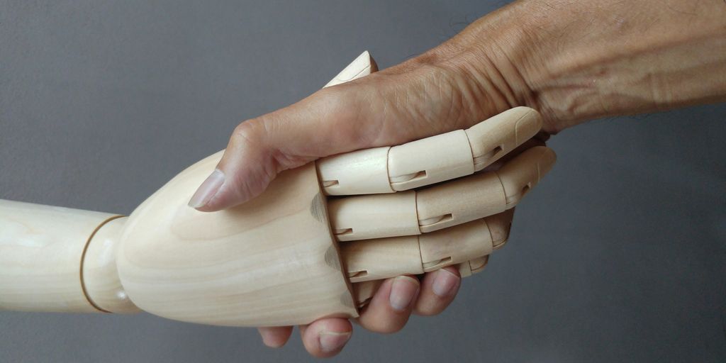 a close up of a person holding a wooden object