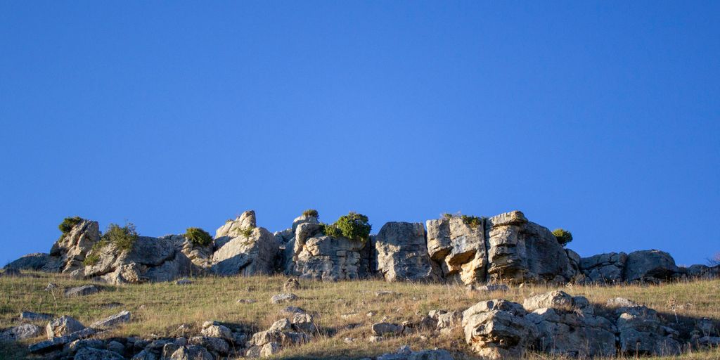 rocky mountain under blue sky during daytime